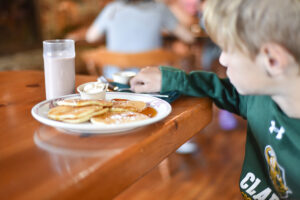 Little boy eating pancakes