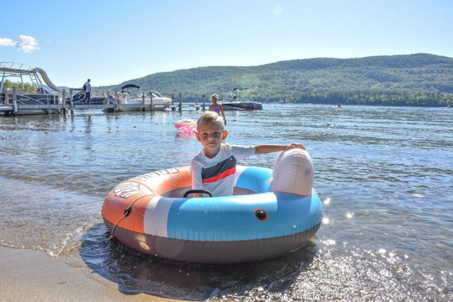Little boy inside water raft on Lake George