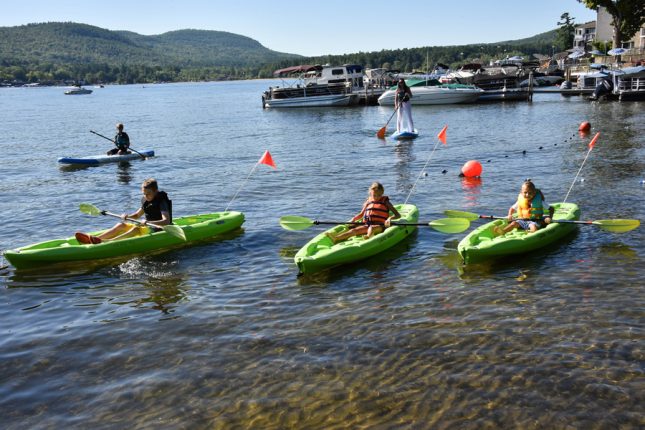Children enjoying kayaks and paddleboards