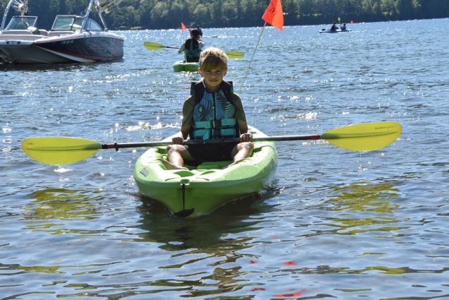 LIttle boy on green kayak